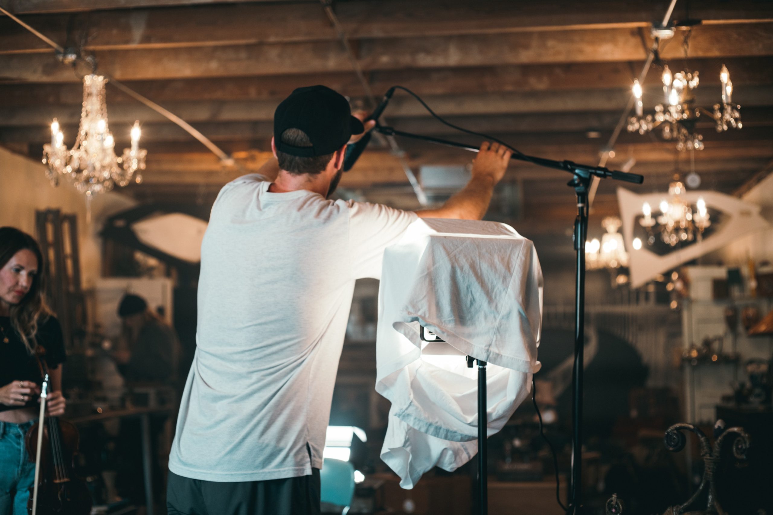 Sound recordist setting up a boom microphone on location