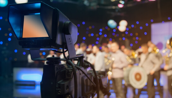 Professional video camera filming a corporate event